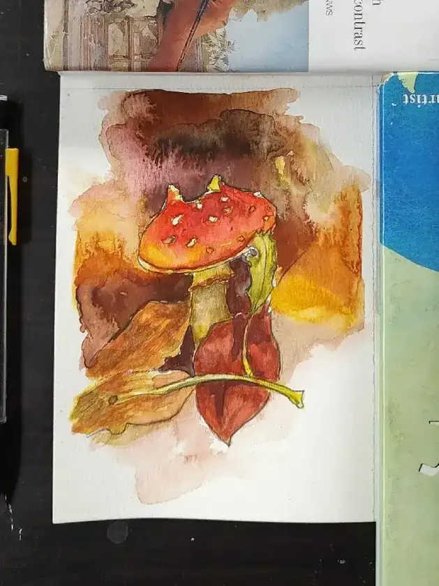 Watercolor of a mushroom surrounded by fall leafs. The background is a bunch of vibrant warm colors that cauliflower into each other