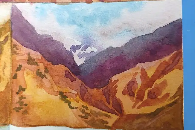 Watercolor of mountain landscape in purple, orange, and yellow.